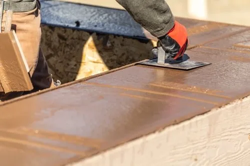 Concrete contractor reviewing a written estimate with a homeowner at a Vancouver job site