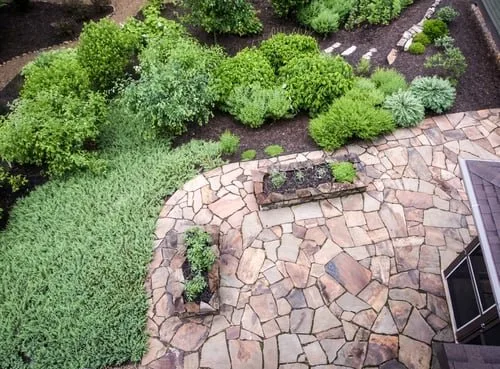Side-by-side comparison of a stamped concrete patio and an interlocking paver walkway in Vancouver